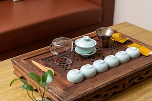 A wooden tray with teaware, including a teapot, cups, and a glass. - Bo Yi Hotel (Guangzhou)