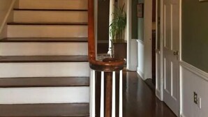 A staircase with wooden steps and a wooden handrail, leading to an upper floor. - Filmed in Movie-Large Charming Midtown 4000 f²,5 BR,8 beds,3.5 bath sleeps 14 (Memphis)