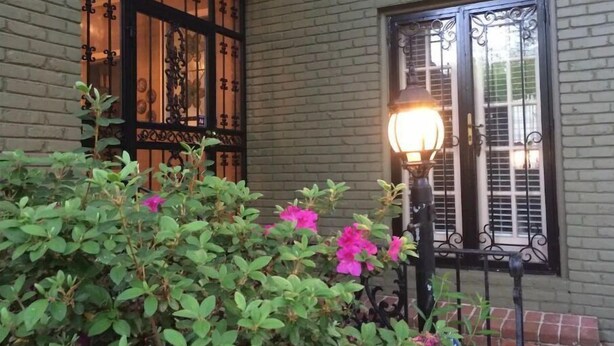 A building with a brick facade, a window with decorative iron bars, and a street lamp. - Filmed in Movie-Large Charming Midtown 4000 f²,5 BR,8 beds,3.5 bath sleeps 14 (Memphis)
