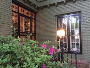 A building with a brick facade, a window with decorative iron bars, and a street lamp. - Filmed in Movie-Large Charming Midtown 4000 f²,5 BR,8 beds,3.5 bath sleeps 14 (Memphis)