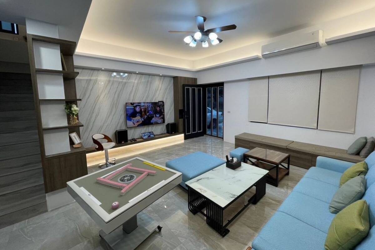 A modern living room with a sofa, coffee table, and entertainment unit.