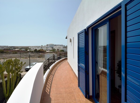 Guests can enjoy a balcony with a tiled floor and white railing.