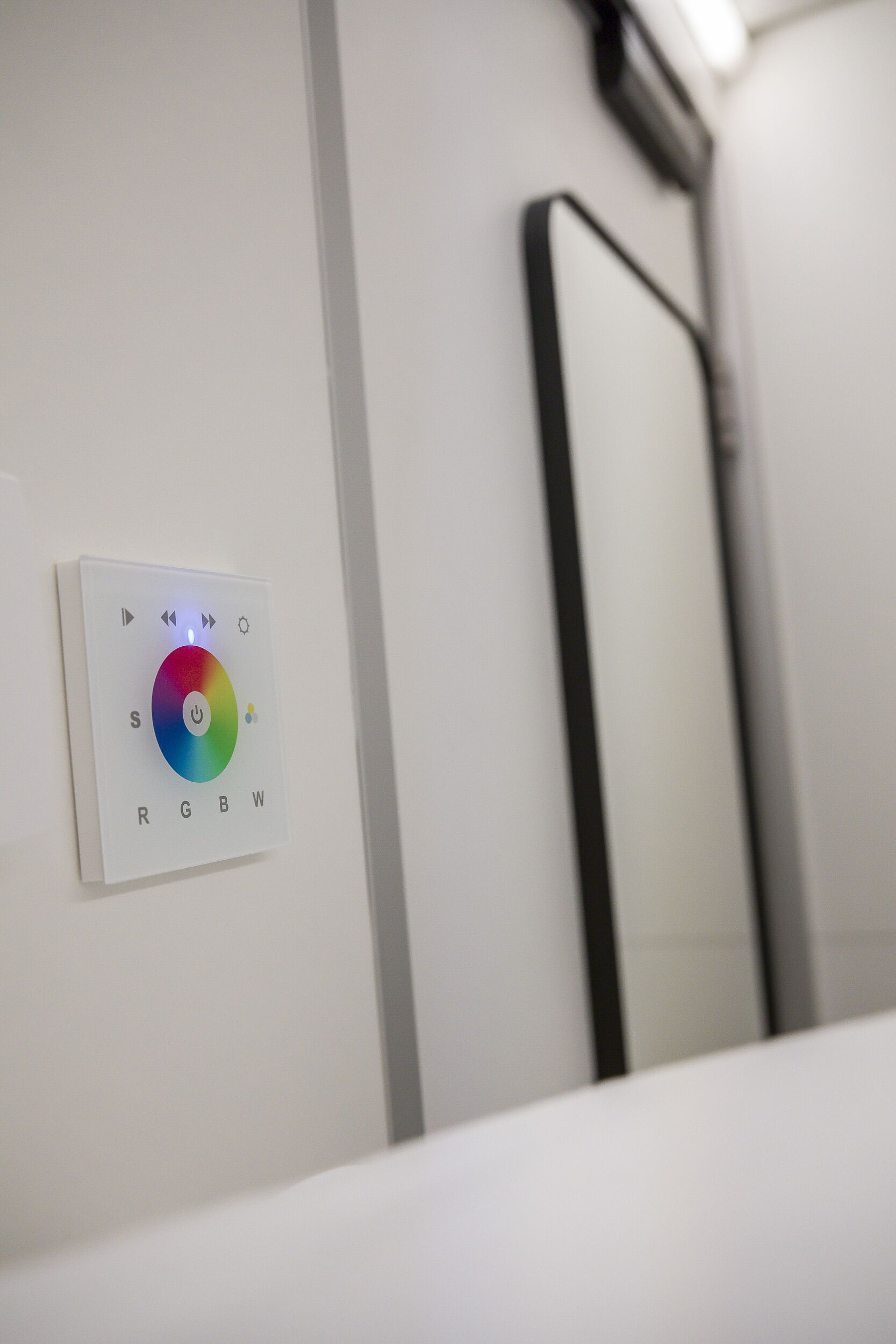 A control panel with color temperature settings labeled RGBW.
