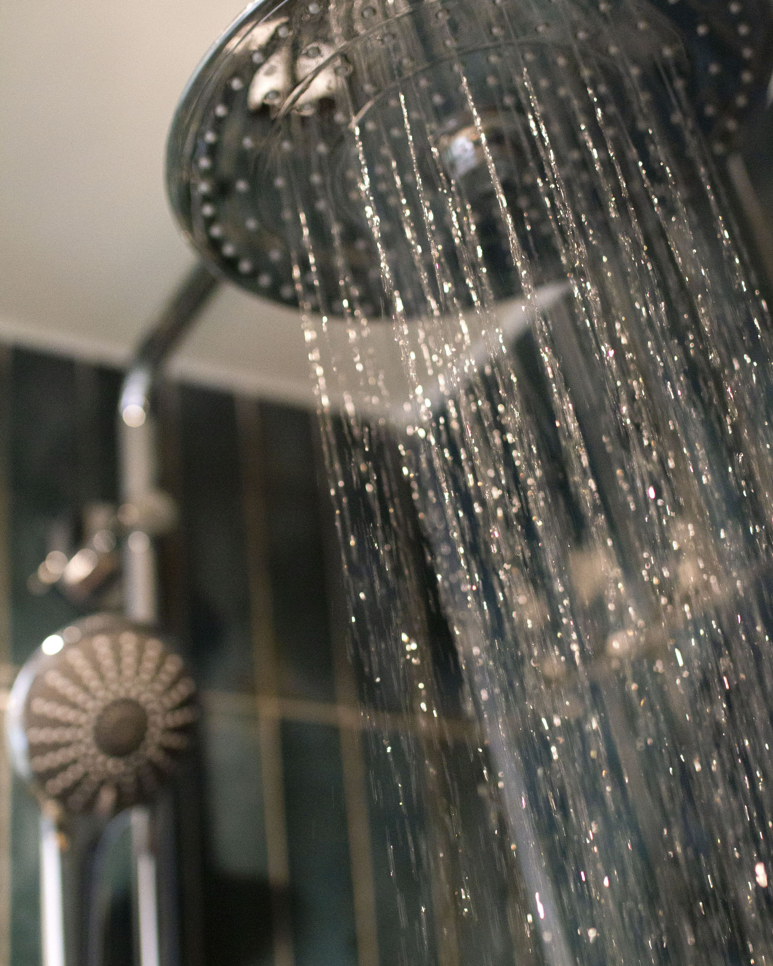 A showerhead with water streaming down.