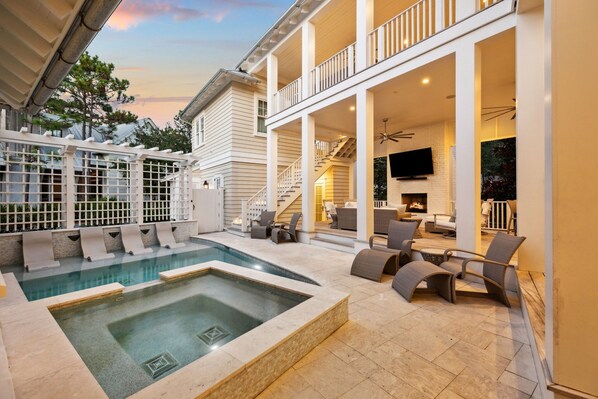 A pool area with a hot tub, outdoor seating, and a staircase leading to an upper deck. - 'Rees on Wiregrass' | Private Pool, Golf Cart, Carriage House | Lake District, WaterColor, FL (Santa Rosa Beach)