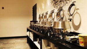 A buffet setup with multiple serving stations, a coffee machine, and a decorative light fixture. - Wonju Boscoa Hotel (Wonju)