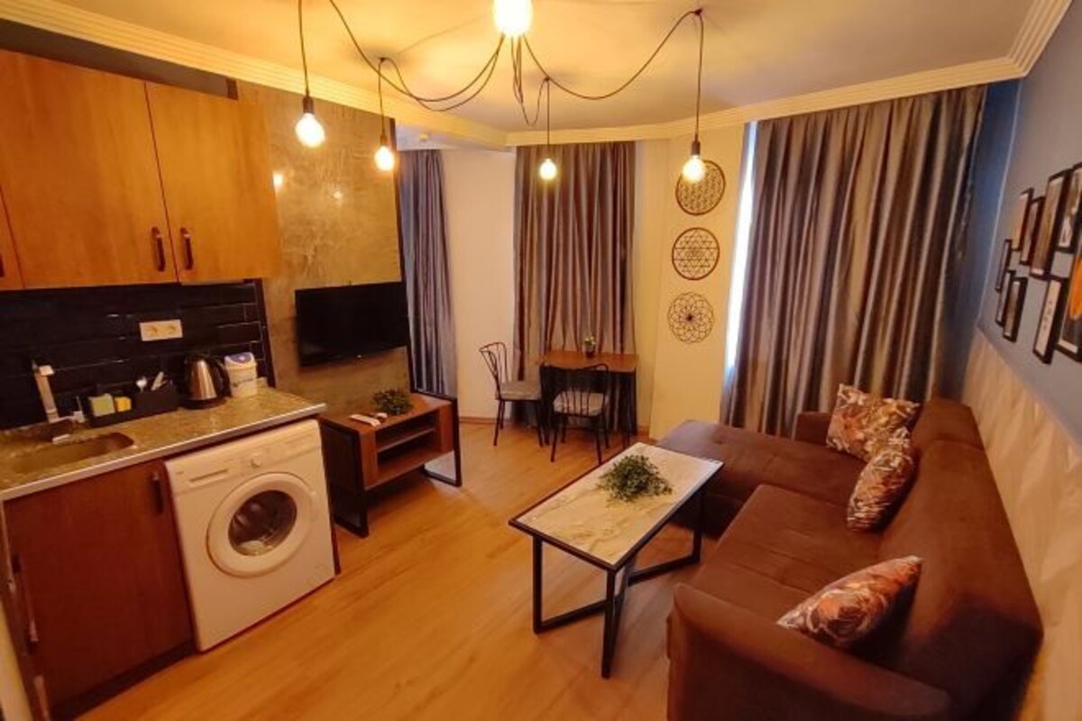 A compact living space with a kitchen, dining area, and seating area.