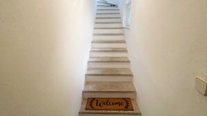 A staircase with a 'Welcome' mat at the bottom. - At home in the love nest (Innsbruck)