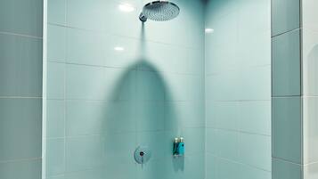 A modern bathroom with a shower, tiled walls, and a visible water heater.