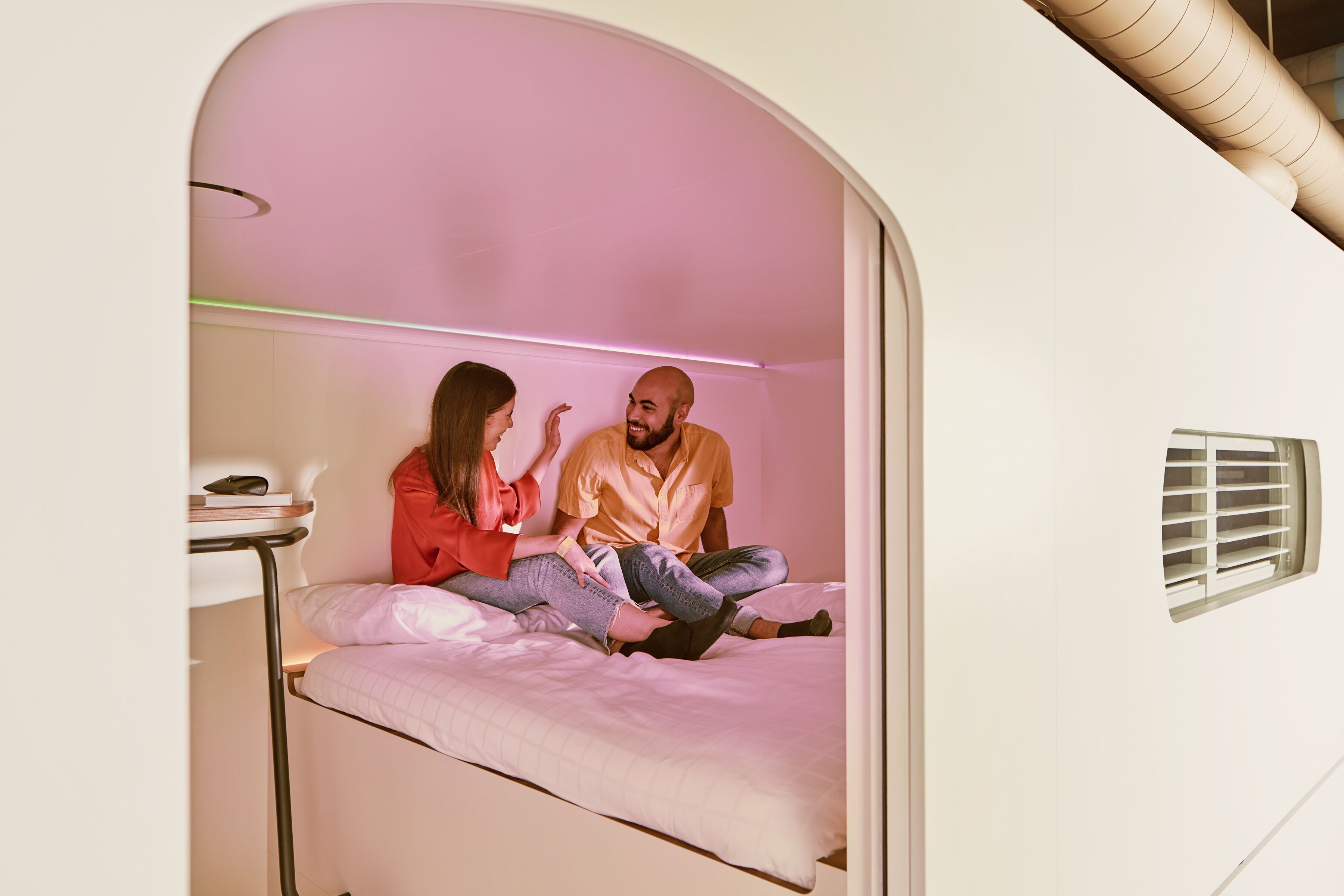 Un dormitorio moderno y acogedor con una cama litera y una pequeña mesa.