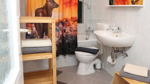 Ein Badezimmer mit Holzregal, Waschbecken, Toilette und Dusche.