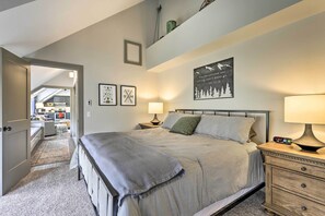 A bedroom with a bed, bedside tables, a lamp, and a wall art piece. - Hot Tub + Ski Shuttle Access: Keystone Condo! (Keystone)