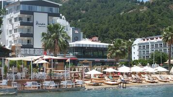 Private beach, white sand, sun loungers, beach umbrellas
