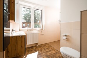 Shower, hair dryer, towels, toilet paper