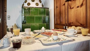 A breakfast table set with various dishes, including eggs, bread, and fruit. - Landhaus Zangerl (Landeck)