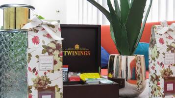 A variety of scented candles and diffusers, including brands like Twinings and Peony, arranged on a table.