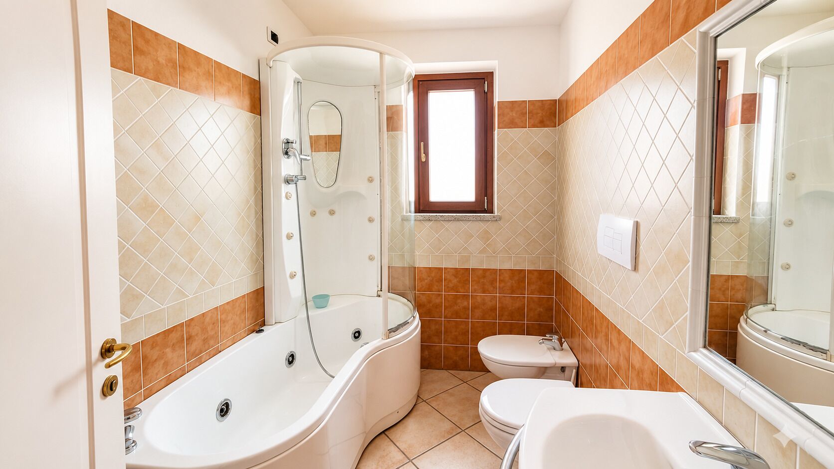 Un baño con bañera, inodoro y cabina de ducha.