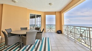 A balcony with a dining table and chairs, a striped rug, and a view of the ocean. - 4 BR En Soleil Directly on Gulf, Beautiful With Free Beach Chairs.  6th Floor (Panama City)