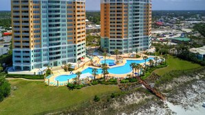 A high-rise hotel with multiple balconies, a swimming pool, and a beach view. - 4 BR En Soleil Directly on Gulf, Beautiful With Free Beach Chairs.  6th Floor (Panama City)