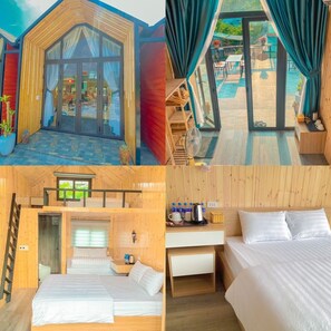 A wooden cabin with a glass entrance, a balcony with a view of the garden, a bed with a wooden headboard, and a small kitchenette.