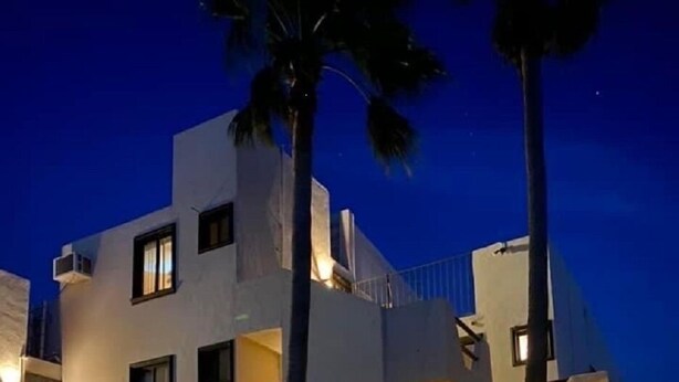 A multi-story building with balconies and a car parked in front. - LaBamba - Great Condo for Adventurer in beautiful San Jose del Cabo (San José del Cabo)