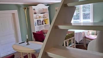 A staircase with a white railing leading to a landing.