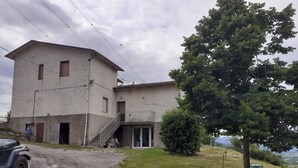 A two-story building with a staircase leading to a balcony. - Easy Lake vacation home (Bargi)