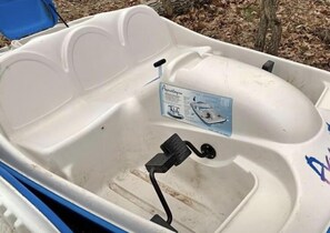 A boat with a white interior, a blue seat, and a label indicating it's an AquaLung. - 5 bedroom 3- bath 8 people capacity pontoon included in Winter Wis. (Winter)