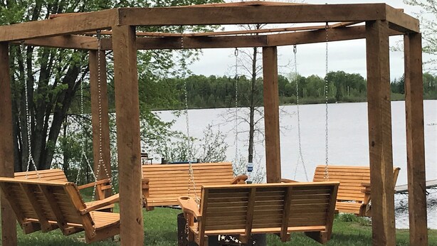 A wooden gazebo with benches and a swing, overlooking a lake. - 5 bedroom 3- bath 8 people capacity pontoon included in Winter Wis. (Winter)