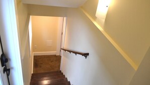 A staircase with wooden steps and a handrail, leading to a room with a door at the top. - Modern Suite Nearby Convention Center (2bd, 1bth) (Portland)