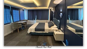 A modern hotel room with a large bed, bedside tables, a desk, and a chair. - Kavacık Asia Hotel (Beykoz)
