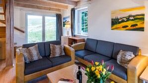 A modern living room with two sofas, a coffee table, and a painting on the wall. - Holiday Hill 65 by Interhome (Cerny Dul/Cista)