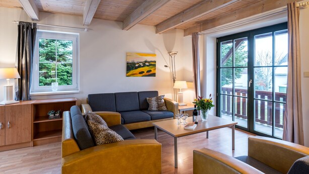 A modern living room with a sofa, armchairs, a coffee table, and a painting on the wall. - Holiday Hill 65 by Interhome (Cerny Dul/Cista)
