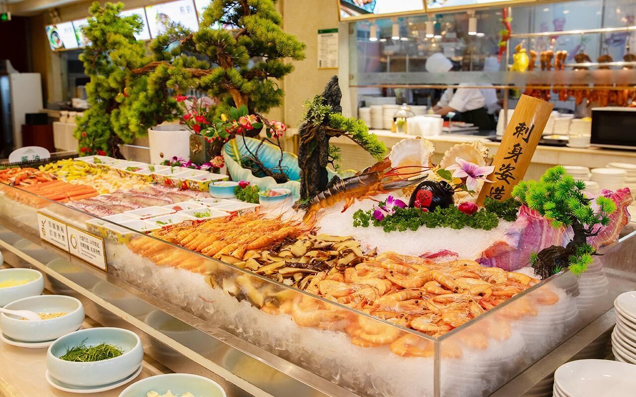 A seafood display with various types of seafood, including shrimp and lobster, arranged on ice.
