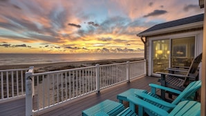 A deck with a view of the beach and ocean during sunset. - Quiet Time | Oceanfront (Virginia Beach)