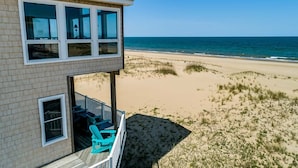 A beachfront property with a balcony overlooking the ocean. - Quiet Time | Oceanfront (Virginia Beach)