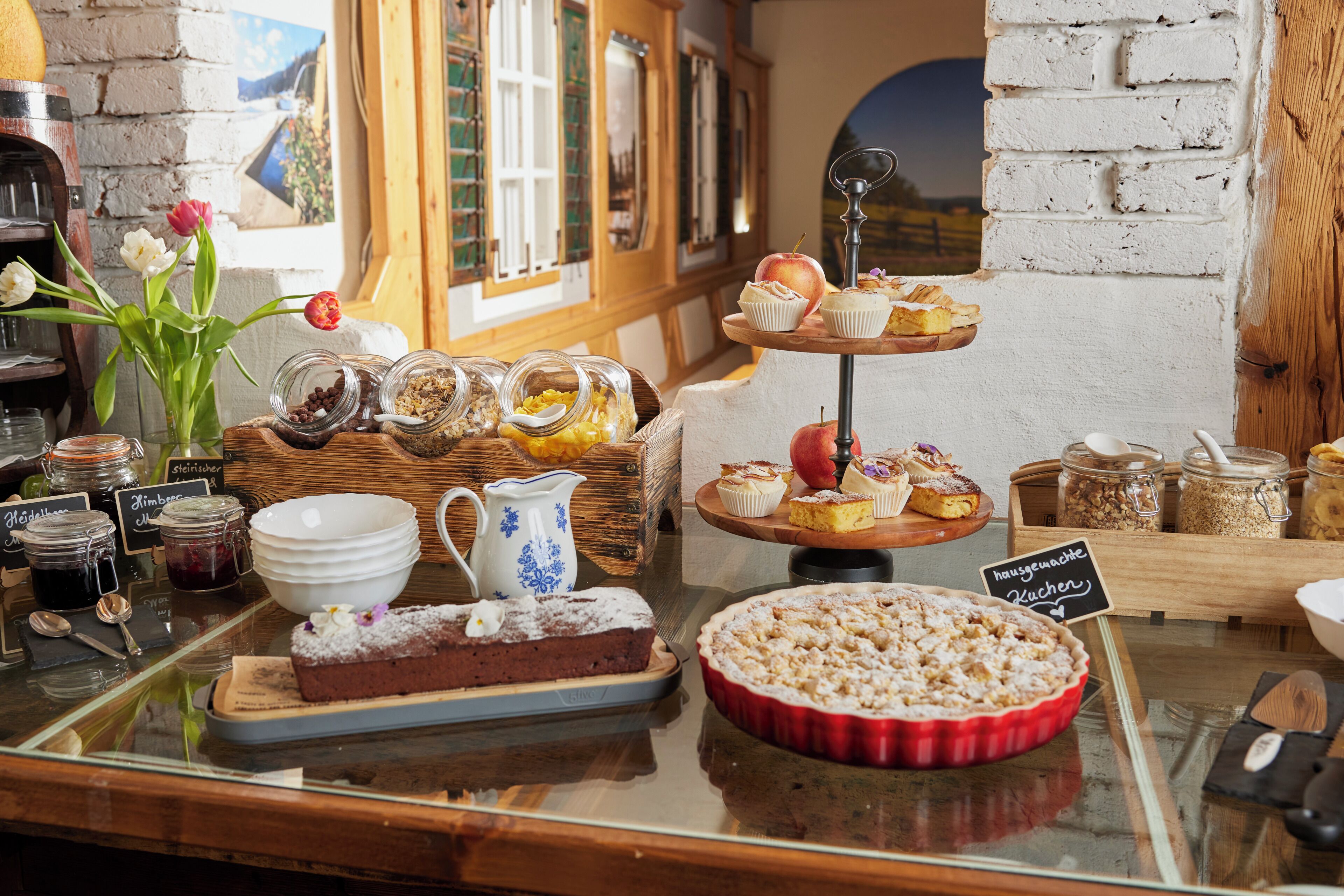 A bakery display with various baked goods and jars of ingredients.