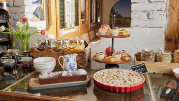 A bakery display with various baked goods and jars of ingredients.