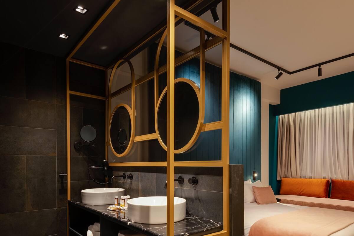 A modern bathroom with a vanity, a bathtub, and a shower area.