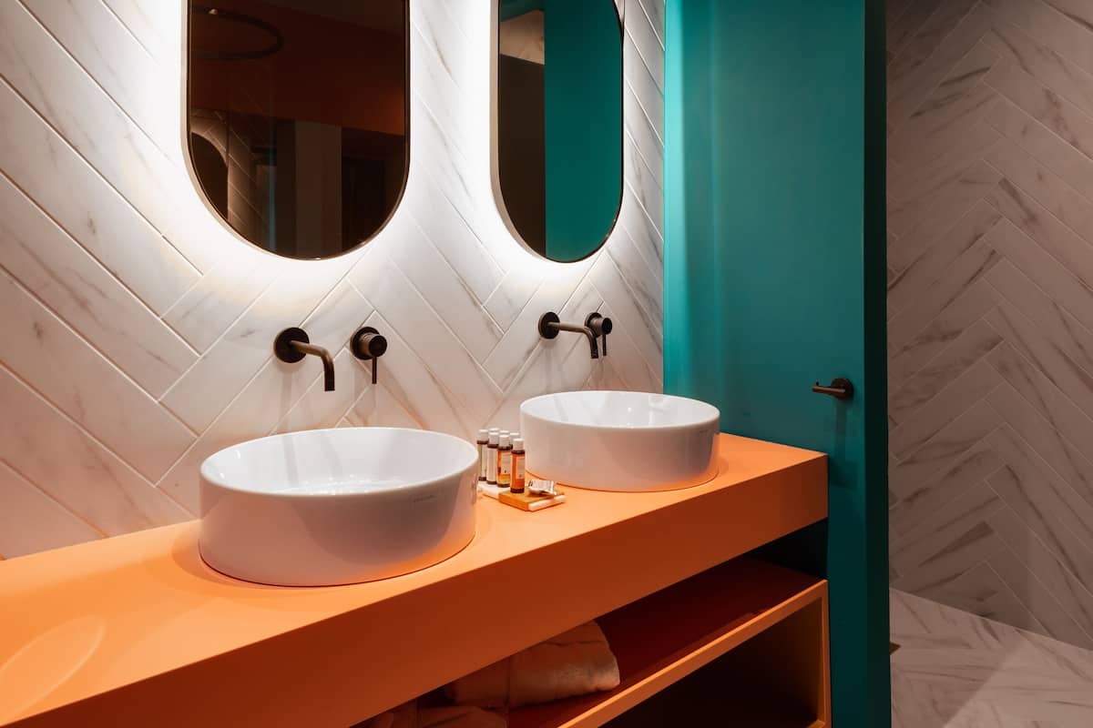 deluxe suite | bathroom | designer toiletries, hair dryer, bathrobes, slippers