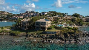 A coastal resort with multiple buildings, a clear view of the ocean, and a sign reading "Gallows Point".