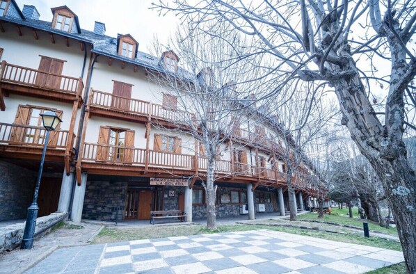 Una hilera de edificios tradicionales de estilo europeo, con balcones de madera y fachadas de piedra.