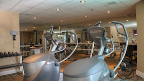 A gym with stationary bikes and dumbbells.