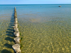 A clear view of a wooden jetty extending into calm waters.