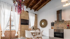 A modern kitchen with white cabinetry, a built-in oven, and a decorative mirror. - MY LOFT 4 YOU RUZAFA STYLE III (Valencia)