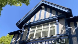 The Bournbrook Inn with a classic architectural style, featuring a prominent gabled roof and large windows. - The Bournbrook Inn (Birmingham)