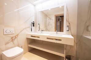 A modern bathroom with a white vanity, a toilet, and a shower area. - Gold Arcos (Benidorm)