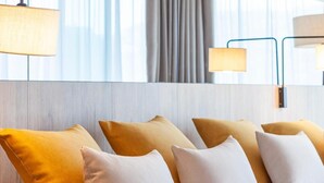 A hotel room with a bed, pillows, a nightstand, and a mirror. - Gold Arcos (Benidorm)