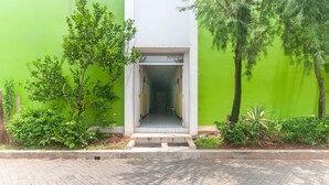 A building entrance with a paved walkway leading to a door. - OYO 3146 Emerald Hill (Karawang)