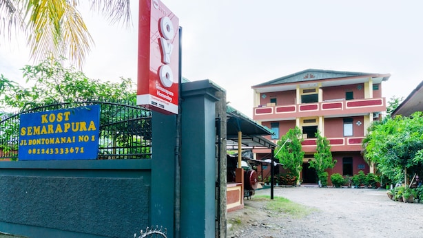 A building with a signboard and a gate.